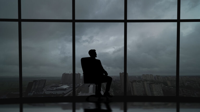 Business Man Is Sitting In The Office Near The Window With A storm approaching